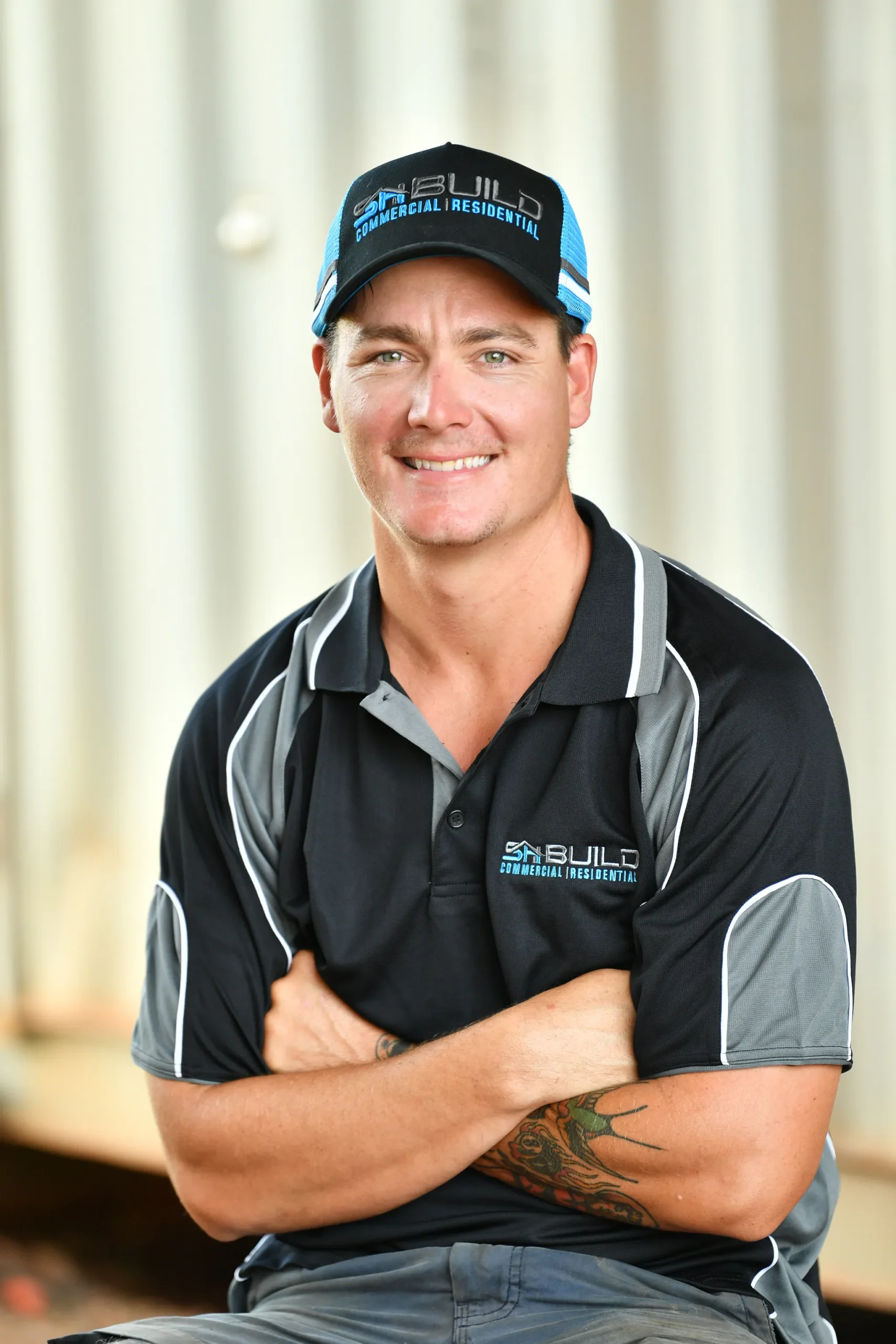 Smiling worker in a branded polo shirt