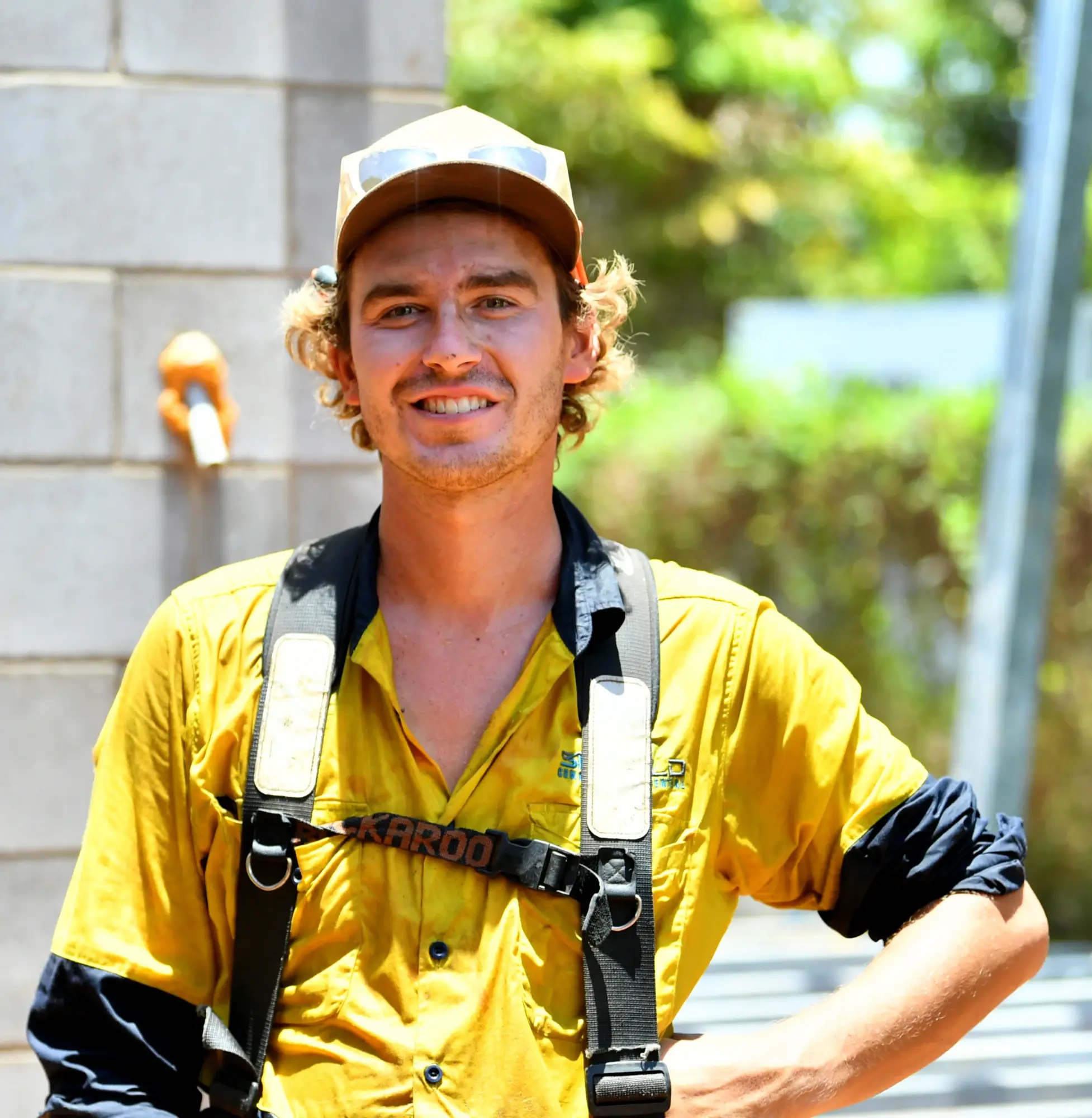 Smiling worker in safety gear outdoors