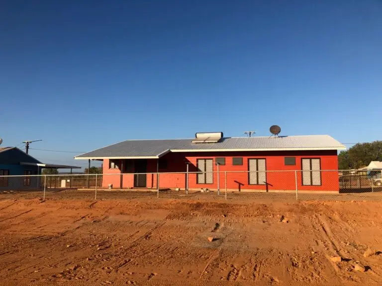 Red brick house on outback dirt lot