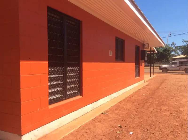 Orange building on red dirt in rural area